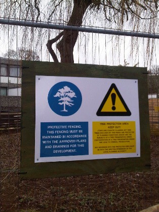 Warning signs on Heras Fence